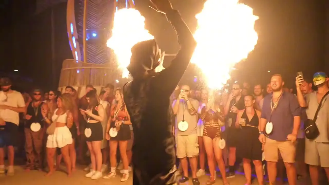 Halfmoon Festival fire performer in front of the crowd at Harmony Beach Club